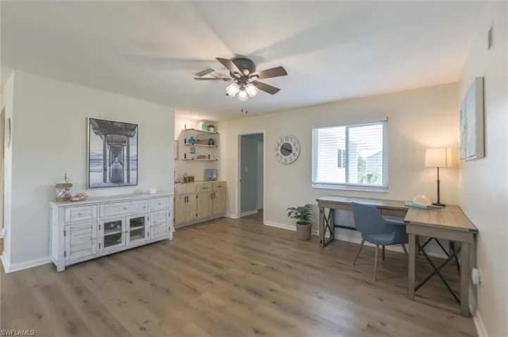 Home office featuring ceiling fan and hardwood / wood-style flooring
