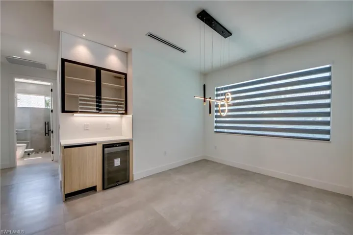Kitchen with hanging light fixtures and wine cooler