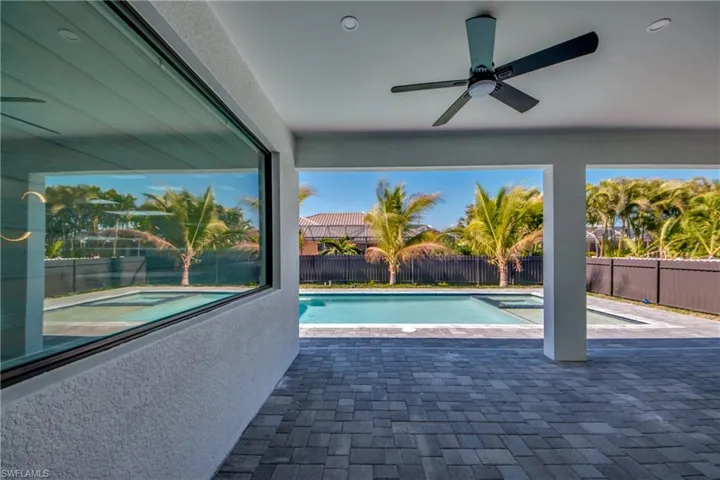 View of swimming pool featuring ceiling fan and a patio area