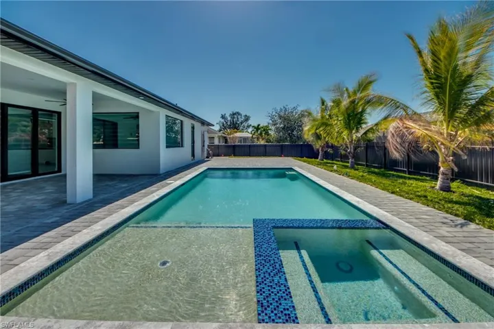 View of swimming pool with a patio and ceiling fan