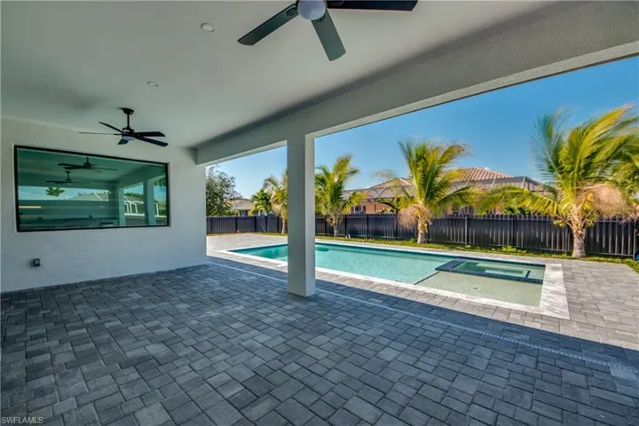 View of pool with a patio, an in ground hot tub, and ceiling fan