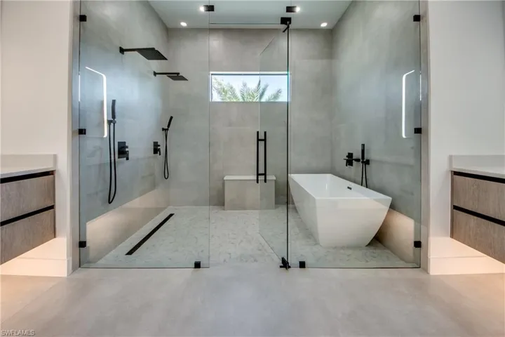 Bathroom featuring vanity and plus walk in shower