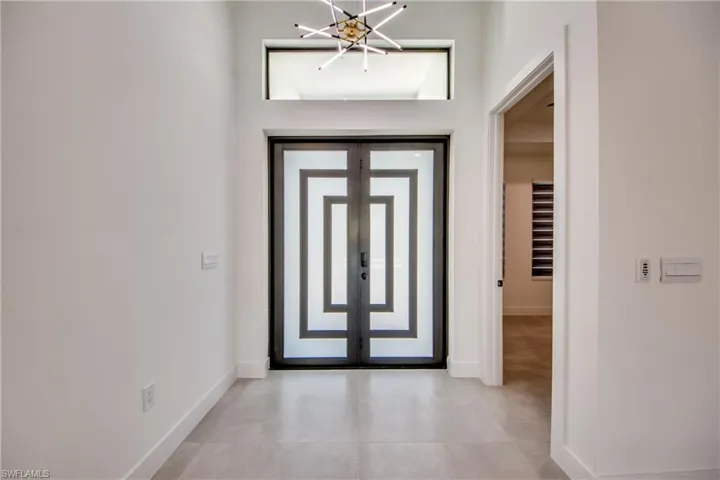 Entryway featuring an inviting chandelier and french doors