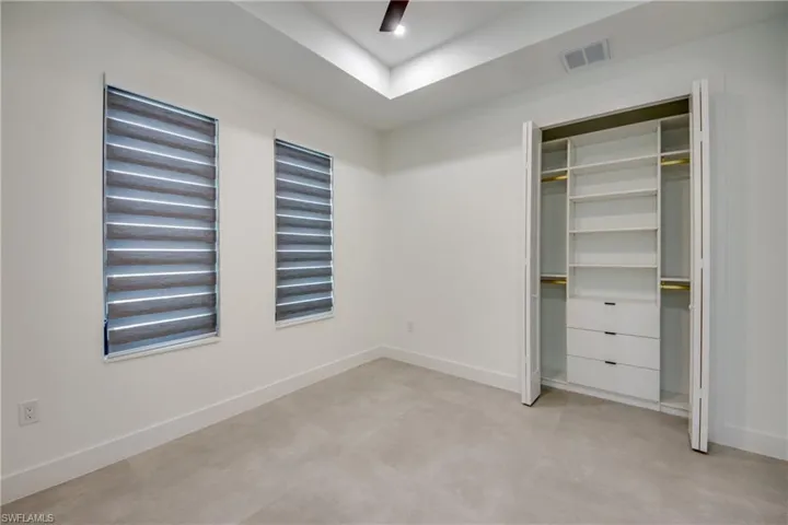 Unfurnished bedroom with a closet and ceiling fan