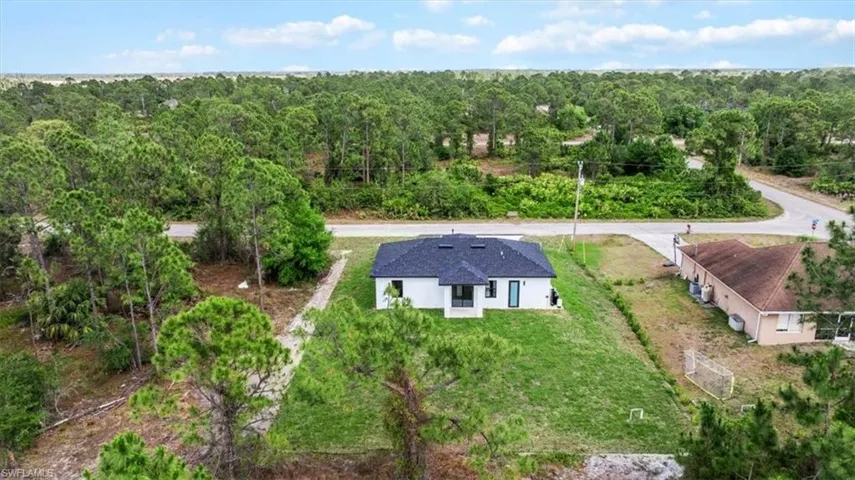 View of subject property with a forest