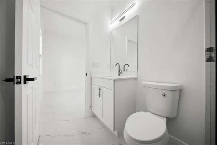 Bathroom with marble look tiles and vanity