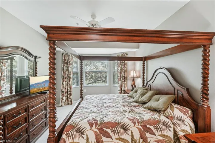 Bedroom featuring ceiling fan and carpet