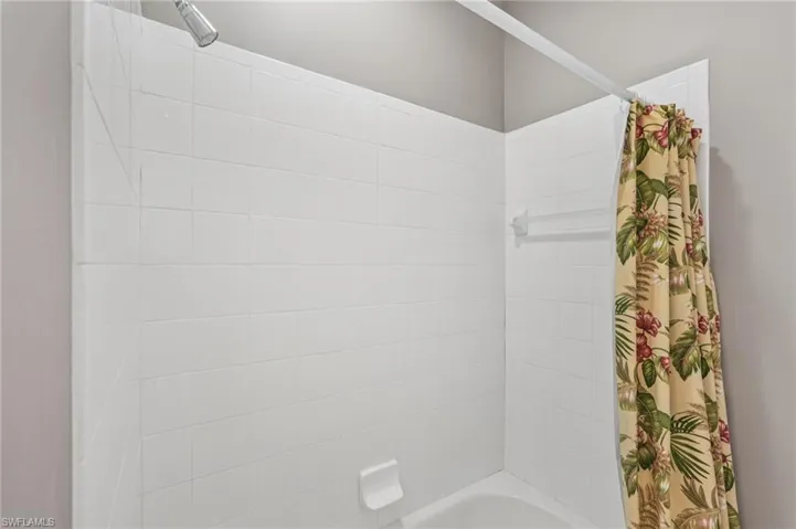 Bathroom with shower / bath combo with shower curtain