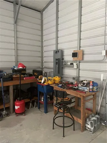 Garage featuring a workshop area and electric panel