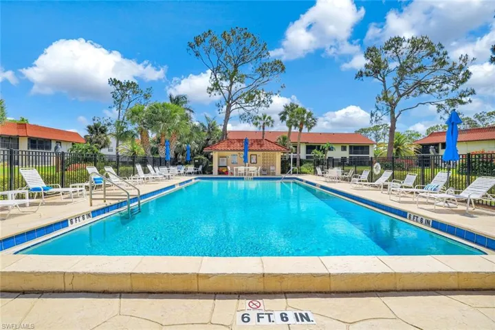 Community pool with fence and a patio