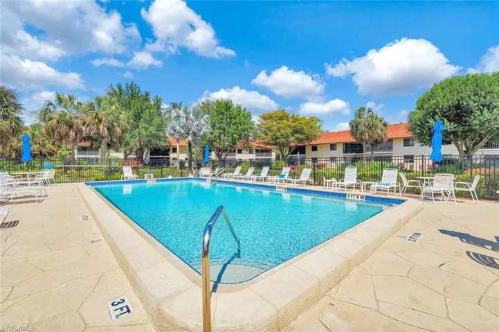 Pool with a patio and fence