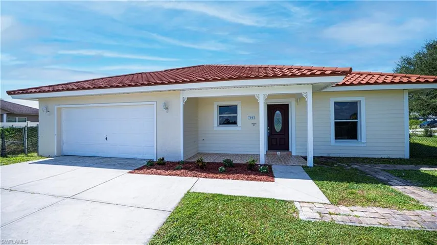 View of front of house featuring a garage and covered porch