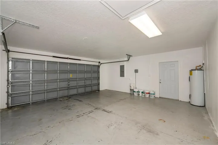 Garage with electric water heater and electric panel