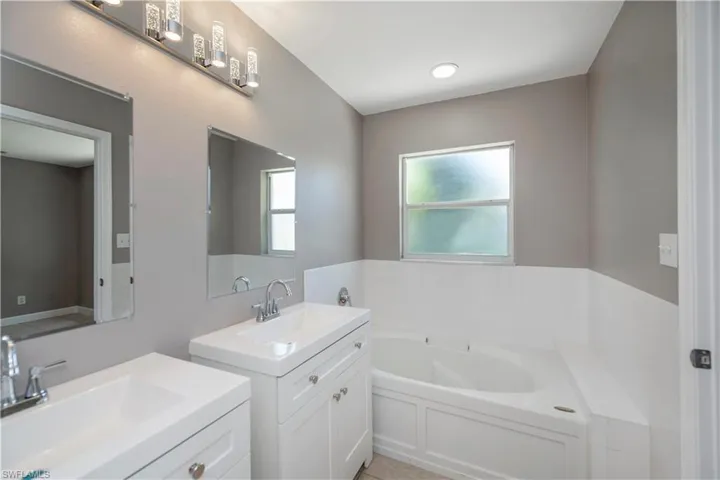 Bathroom with a tub and double sink vanity