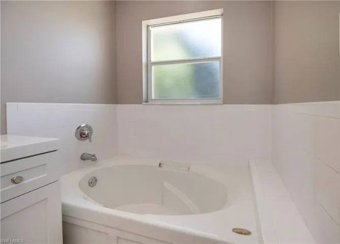 Bathroom with a tub to relax in and vanity