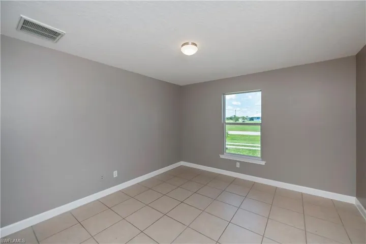 Empty room featuring light tile patterned floors