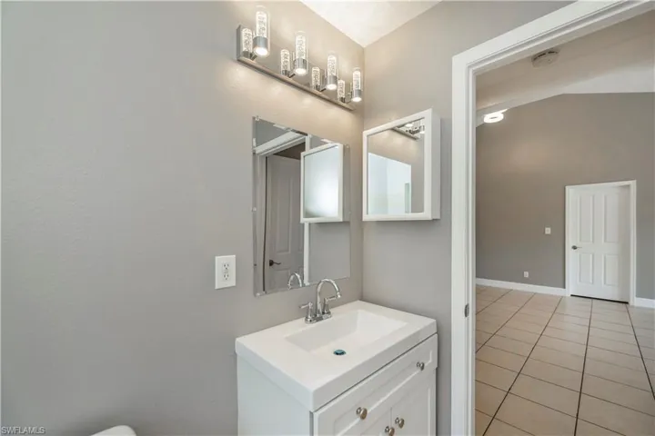 Bathroom with tile patterned floors and vanity