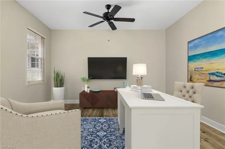 Living room with ceiling fan and hardwood / wood-style floors