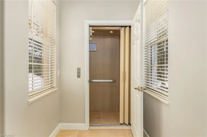 Hallway with light tile patterned floors