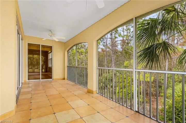 Unfurnished sunroom featuring ceiling fan