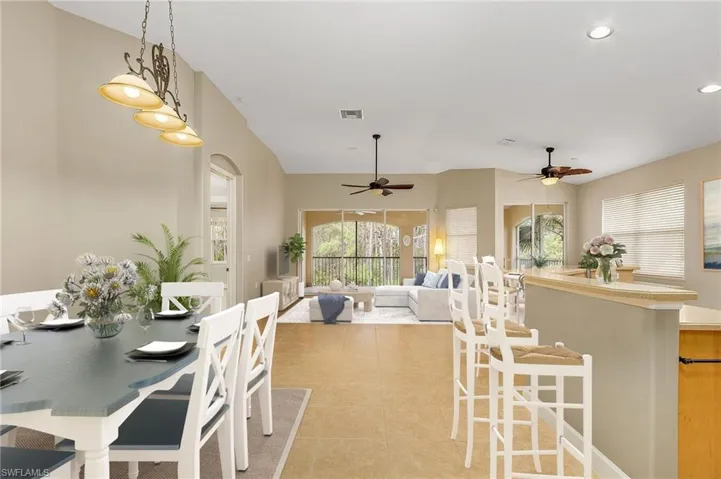 Tiled dining space featuring ceiling fan