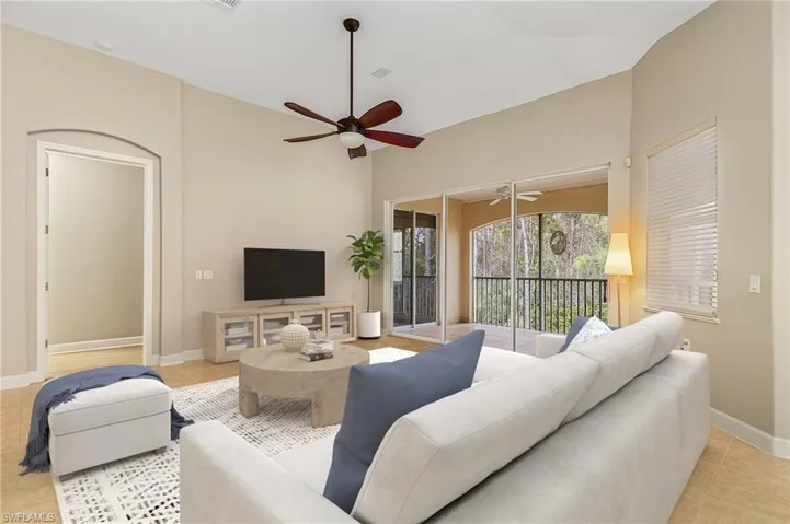 Living room with ceiling fan and light tile patterned floors