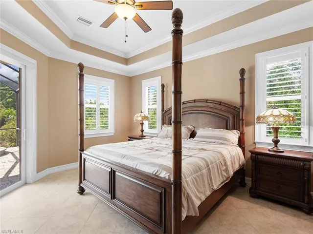 Bedroom featuring visible vents, a raised ceiling, baseboards, access to outside, and light tile patterned flooring