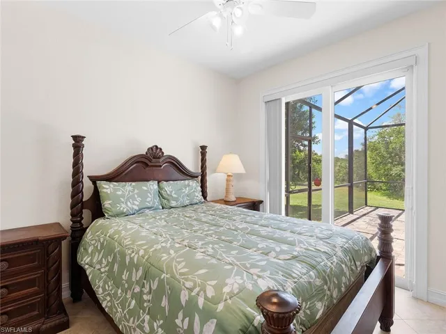 Tiled bedroom with access to outside, baseboards, and ceiling fan