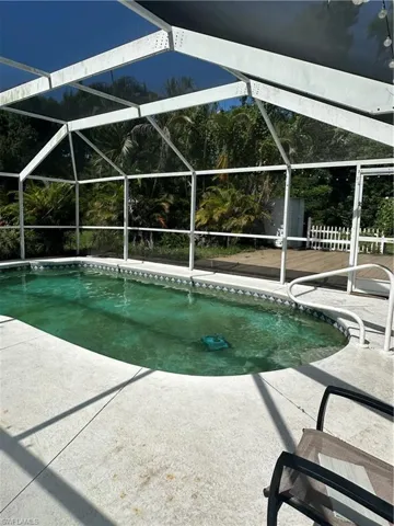 Swimming pool featuring a patio and a lanai