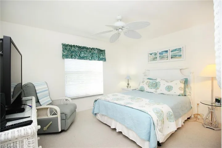 Bedroom with ceiling fan and carpet