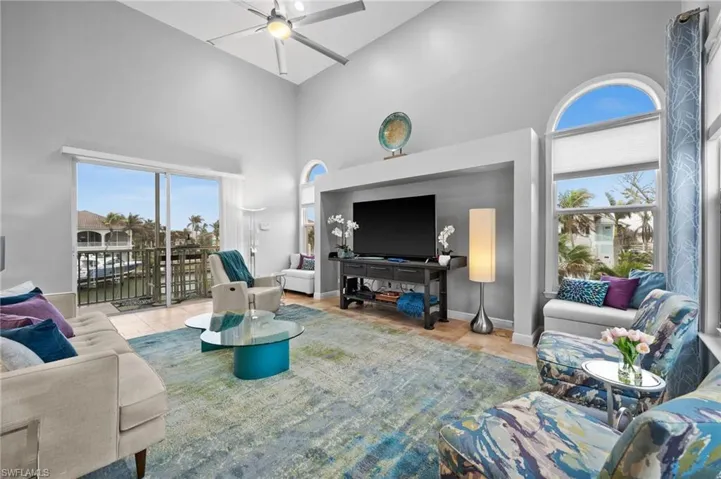 Living room with high vaulted ceiling and ceiling fan