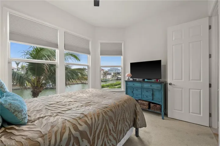 Bedroom featuring ceiling fan and light carpet