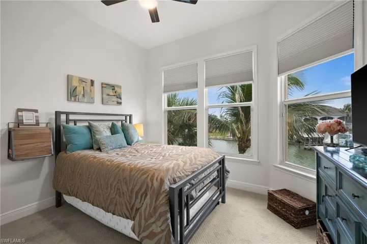 Bedroom featuring light colored carpet and ceiling fan