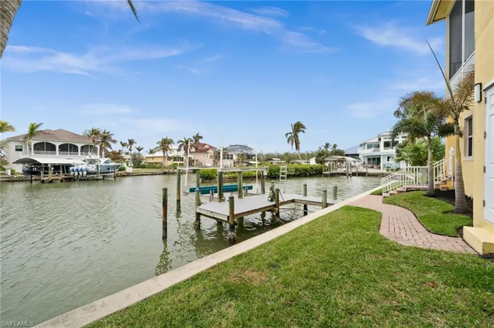 Dock area featuring a lawn and a water view