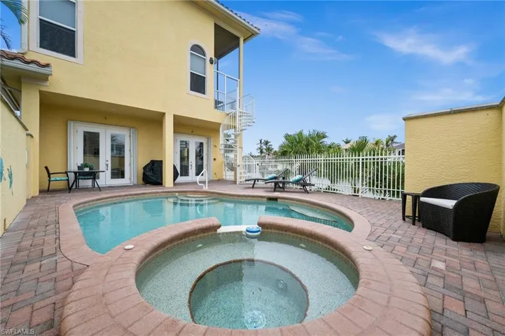 View of pool featuring an in ground hot tub, a patio, and french doors