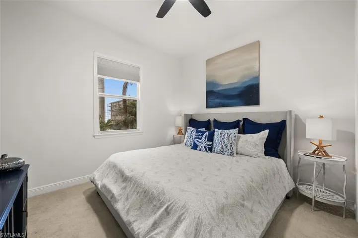 Carpeted bedroom with ceiling fan