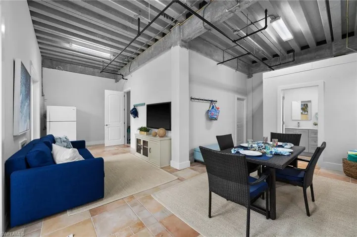 Tiled dining room featuring a high ceiling