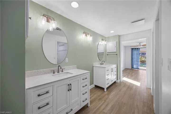 Full bathroom with a shower stall and light wood-type flooring