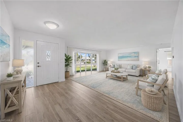 Foyer entrance featuring light wood-style floors and baseboards