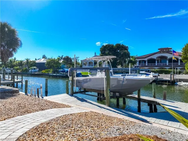 Dock area featuring boat lift and a water view