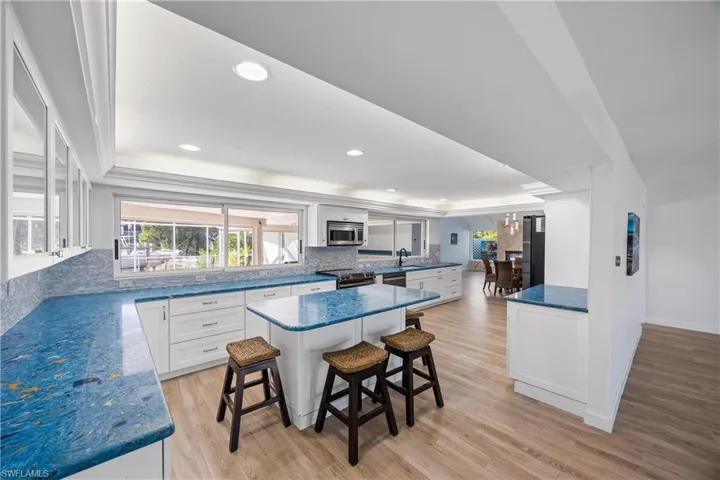 Living area with light wood-style floors and recessed lighting