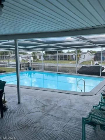 View of pool featuring a patio and a lanai