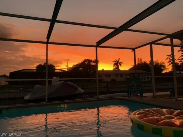Pool at dusk with a lanai