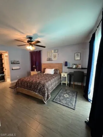 Bedroom featuring wood-type flooring and ceiling fan