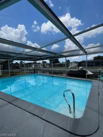 View of pool with a lanai