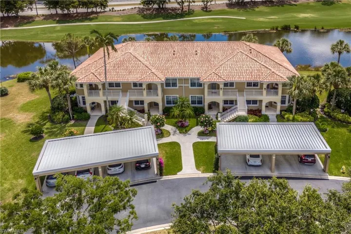 Birds eye view of property with a water view