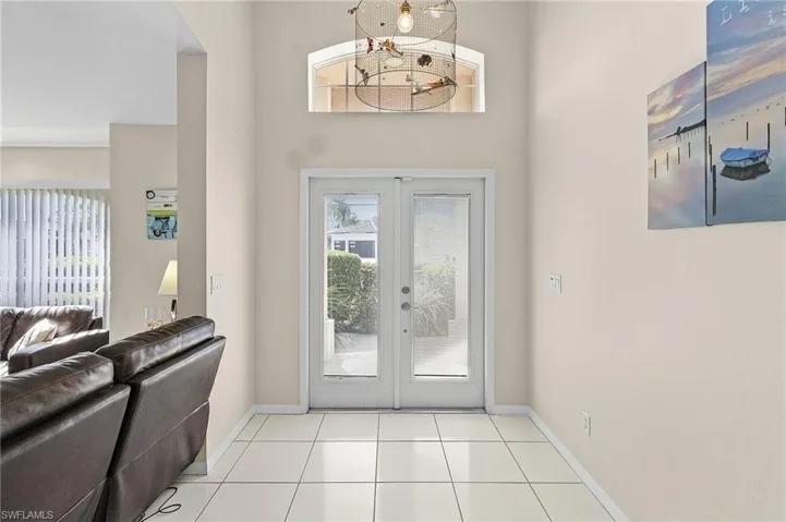Tiled entrance foyer with french doors