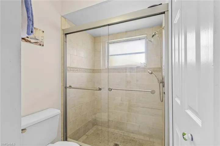 Bathroom with an enclosed shower and toilet