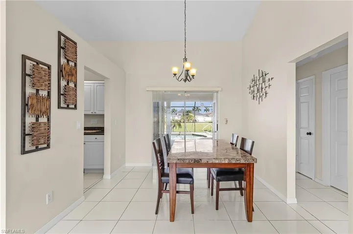 Dining space featuring a chandelier and light tile patterned floors