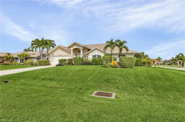 Ranch-style house with a garage and a front yard